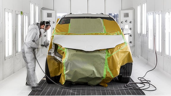 Collision Center Technician Painting a Vehicle | Stone Mountain Toyota in Lilburn GA